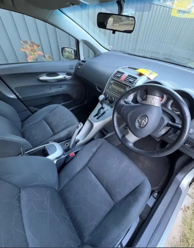 The same Toyota hatch driver's seat and dash after the detail